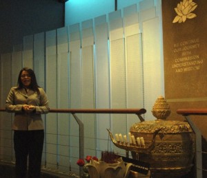 Dary Mien, executive director of the Cambodian American Heritage Museum, explains the names etched on the glass panel memorial