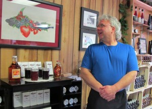 Winery owner John Lucas admires the Garden Bay logo art by his daughter Emily