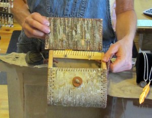 Jill shows a statement purse of bark with a wooden button closure