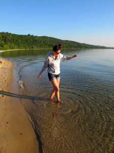 Paige tests the water at Sand Point beach just east of Munising