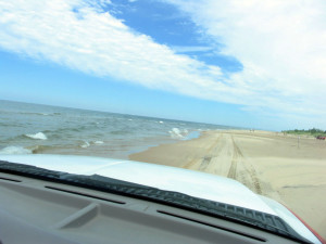 The dune ride briefly splashes along the Lake Michigan shore