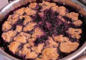 Dabs of dough top the berry mixture and steam cook under the skillet lid