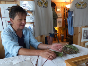 Barb Erickson works on a  twig creation in her studio/gallery on the Lake Superior shore