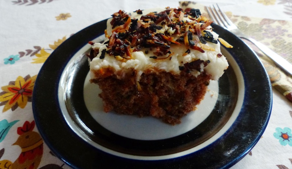 Carrot cake topped with cream cheese icing and toasted coconut