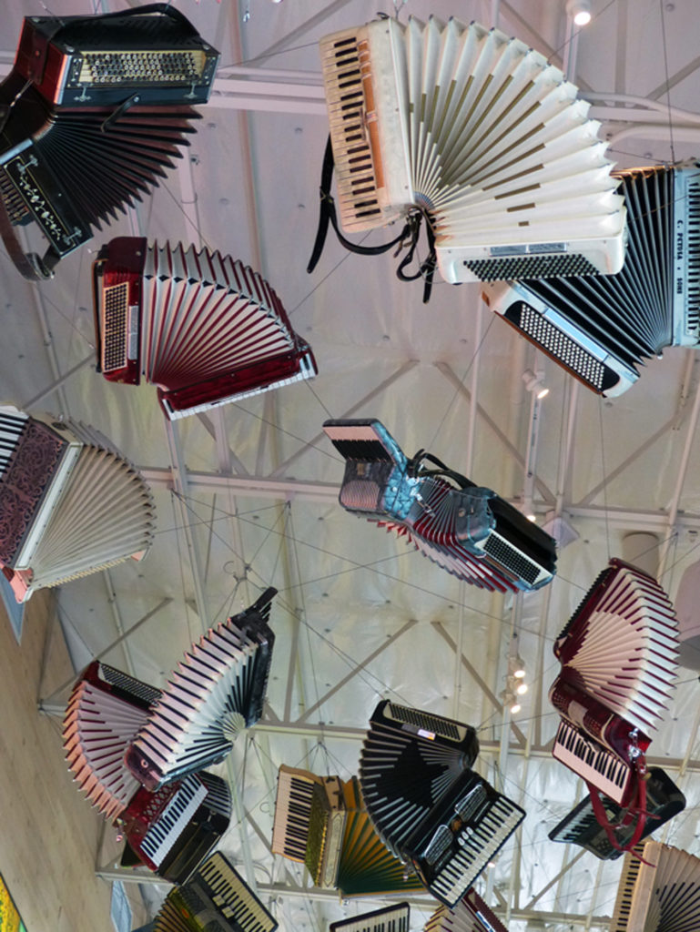 Accordions dangle from the ceiling of Collections Cafe at Chihuly Garden and Glass in Seattle, Washington