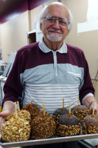 Paul Beardsley and a selection of caramel and chocolate covered apples